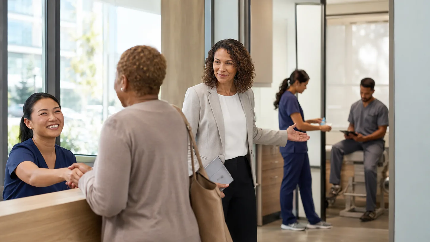 A clinic manager connects a patient with care teams working in different rooms of a multi-location clinic